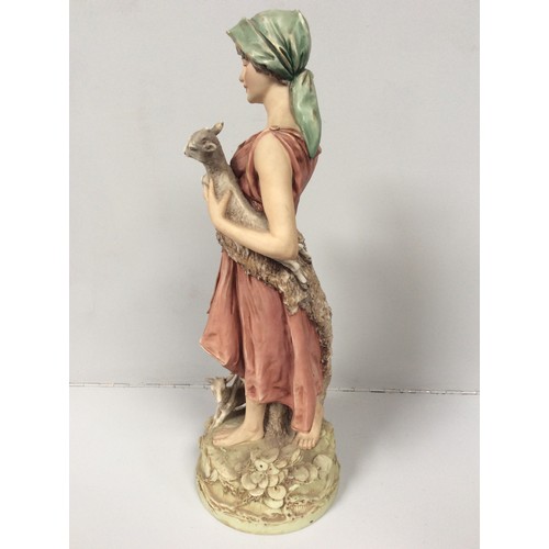 39 - A Royal Dux porcelain figure of a shepherdess with two goats at her feet and one in her arms, model ... 