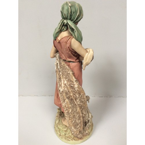 39 - A Royal Dux porcelain figure of a shepherdess with two goats at her feet and one in her arms, model ... 