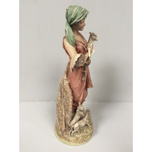 39 - A Royal Dux porcelain figure of a shepherdess with two goats at her feet and one in her arms, model ... 