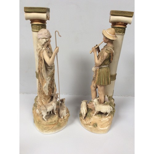 37 - A pair of Royal Dux porcelain figures of a shepherd and shepherdess modelled next to classical Ionic... 