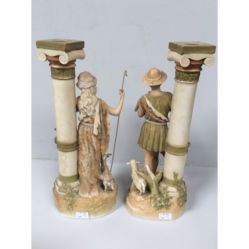 37 - A pair of Royal Dux porcelain figures of a shepherd and shepherdess modelled next to classical Ionic... 