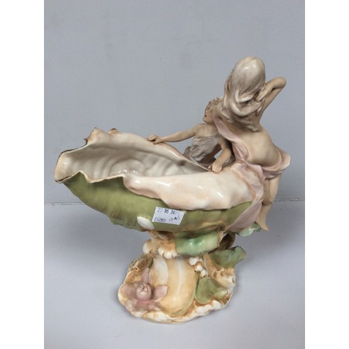 40 - A Royal Dux porcelain figural centrepiece modelled as a conch shell vase mounted with two semi-naked... 