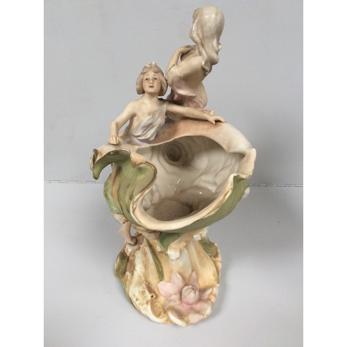 40 - A Royal Dux porcelain figural centrepiece modelled as a conch shell vase mounted with two semi-naked... 