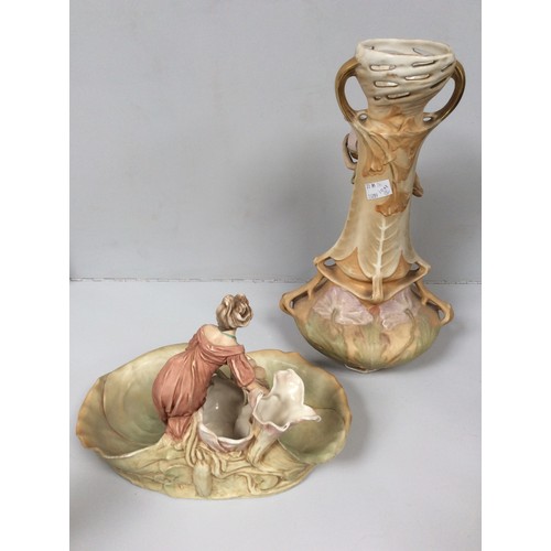 41 - A Royal Dux porcelain figural centrepiece/nut dish, modelled as a maiden standing on a flowering lil... 