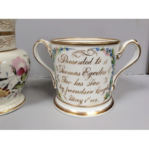 53 - An early 19th century Staffordshire porcelain two-handled loving cup painted with roses and gilt ins... 