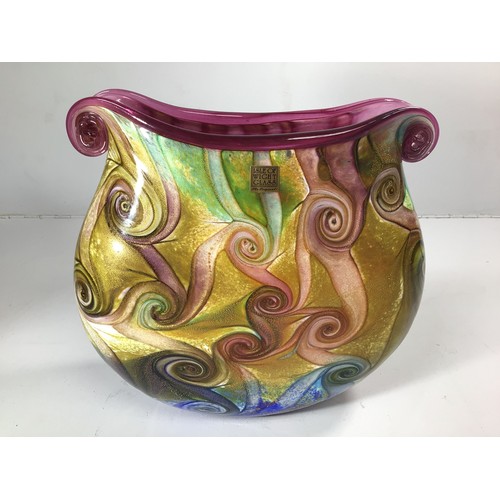 61 - An Isle of Wight studio glass oval vase with twin scrolled ends, decorated with a swirl design in hu... 