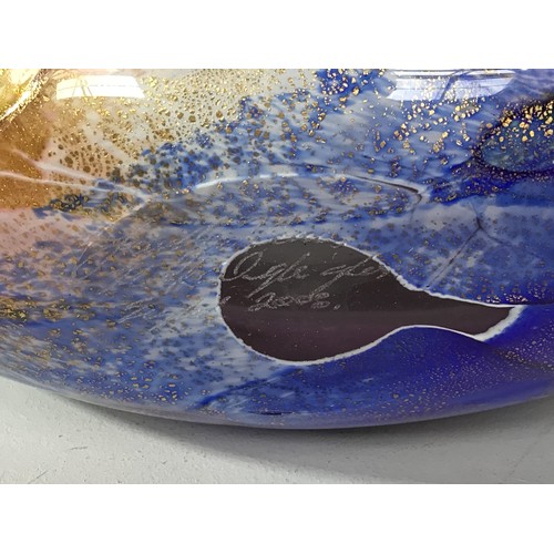 61 - An Isle of Wight studio glass oval vase with twin scrolled ends, decorated with a swirl design in hu... 