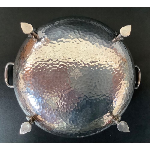 42 - A silver-plated Arts and Crafts, twin-handled, planished bowl by Mappin and Webb, raised on four sha... 