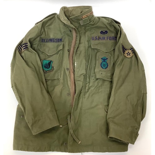 432 - A green US Airforce flight jacket with applied badges for Pacific Air Forces, Sergeant arm patch and... 