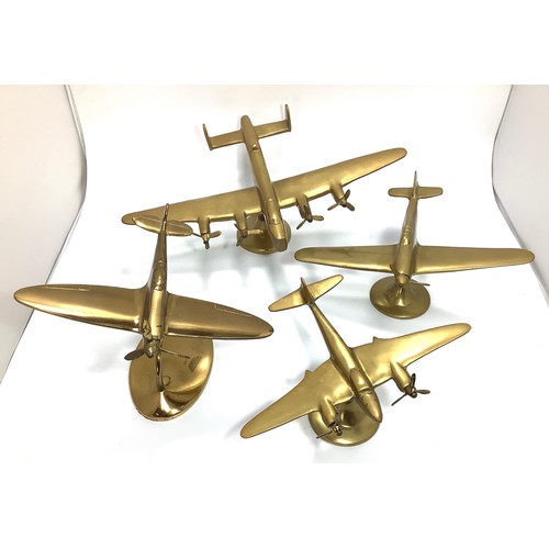435 - Four brass desk model aeroplanes raised on stands to brass bases including an Avro Lancaster Bomber ... 
