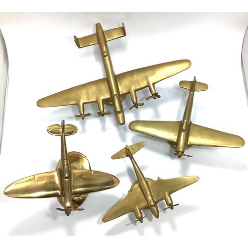 435 - Four brass desk model aeroplanes raised on stands to brass bases including an Avro Lancaster Bomber ... 