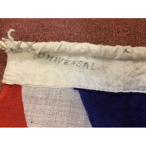 460 - A Royal Navy Ensign flag 130cm x 89cm together with a Union Jack stamped with broad arrow and handwr... 