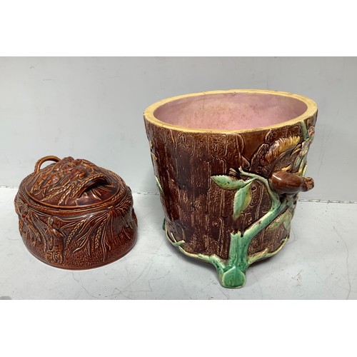 15 - A 19th century Majolica pottery jardiniere modelled as a tree-stump with vines, fruiting flowers and... 
