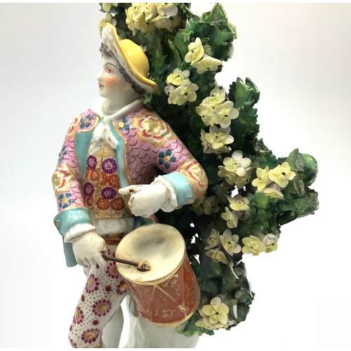2 - A Chelsea Gold Anchor figure of a drummer boy, modelled on a rococo base against floral bocage, 'gol... 