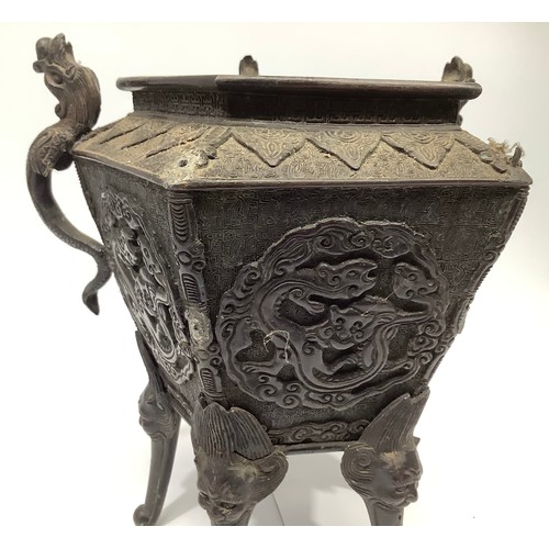 58 - A Chinese patinated bronze censor of tapering pentagonal form, cast with five dragon handles (two la... 