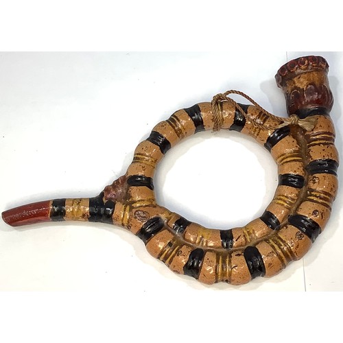 1 - A 19th century English Prattware style coiled ‘serpent’ pottery pipe, finished with beige, black, ye... 