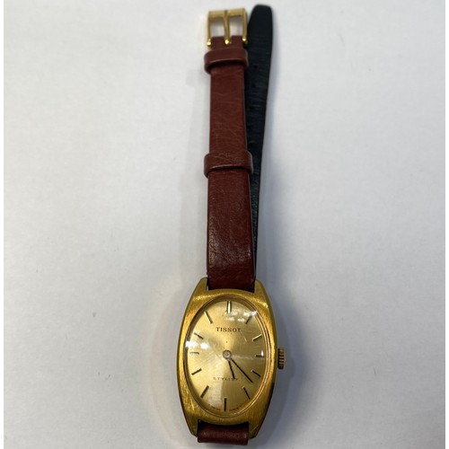 124 - A lady’s yellow metal Tissot wristwatch with oval case, gold coloured dial with batons denoting the ... 