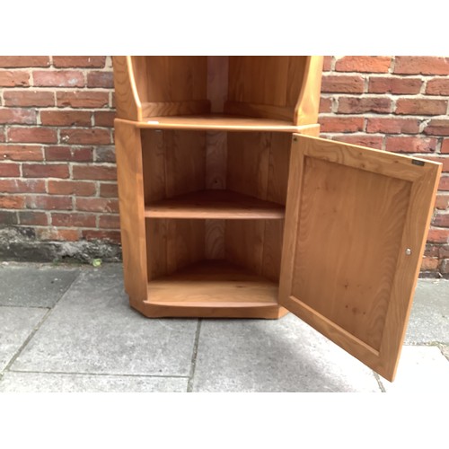 613 - An Ercol blonde elm corner cabinet, with two shelves above a single cupboard, 180 x 75cm