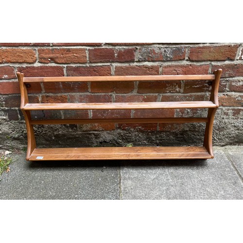 614 - Three Ercol blonde elm hanging corner shelves, together with a wall hanging set of two plate shelves... 