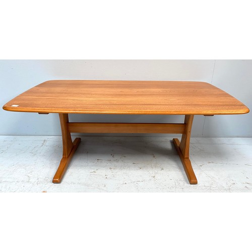 615 - An Ercol blonde elm coffee table, of rectangular form and raised on trestle supports with stretcher,... 