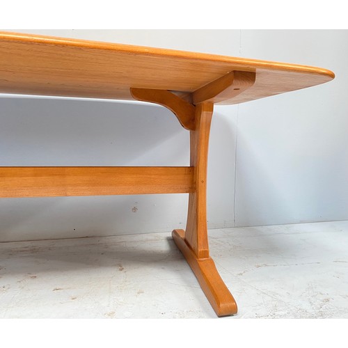 615 - An Ercol blonde elm coffee table, of rectangular form and raised on trestle supports with stretcher,... 