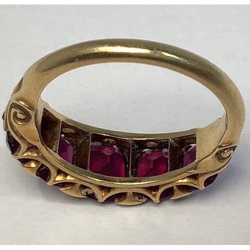 133 - A gold and garnet ring, tests as 18ct, set with five graduated garnets, the largest measuring 7x6mm,... 