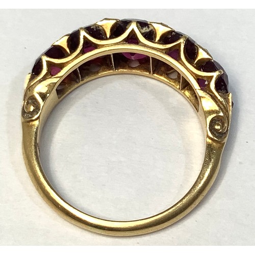 133 - A gold and garnet ring, tests as 18ct, set with five graduated garnets, the largest measuring 7x6mm,... 