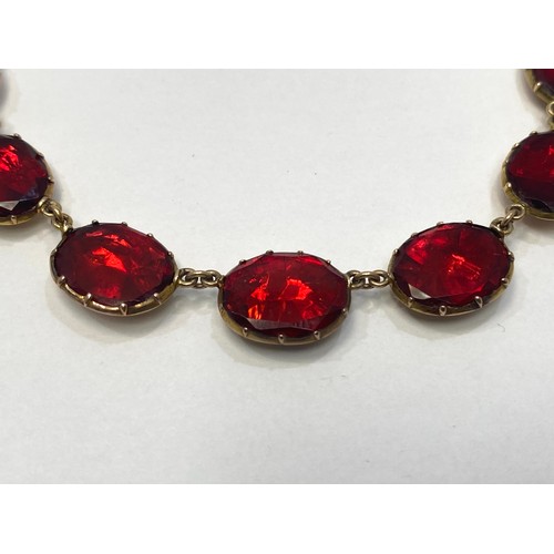 151 - A 19th century Georgian yellow metal (tests as 14ct) garnet 'coloured' paste stone rivière necklace ... 