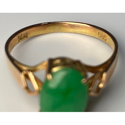 186 - A 14ct gold ring, set with an oval shaped cabochon jade, in a four-claw setting, finger size J, toge... 