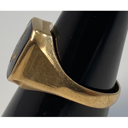 183 - A yellow metal (marked 9ct) signet ring, with black onyx top with masonic symbol in gold, weighs 5.1... 