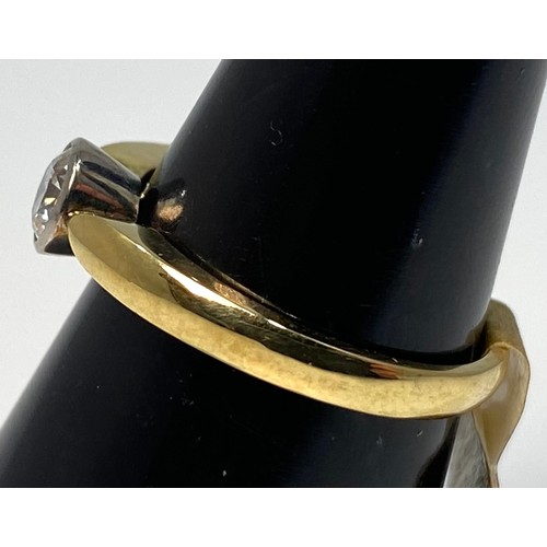 173 - An 18ct yellow gold diamond ring, set with a round brilliant cut diamond in a rub-over bezel setting... 