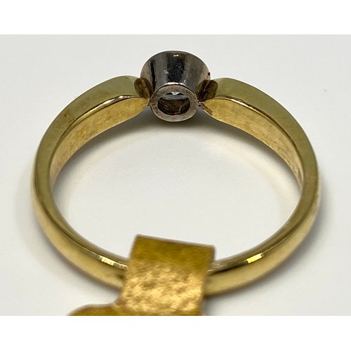 173 - An 18ct yellow gold diamond ring, set with a round brilliant cut diamond in a rub-over bezel setting... 