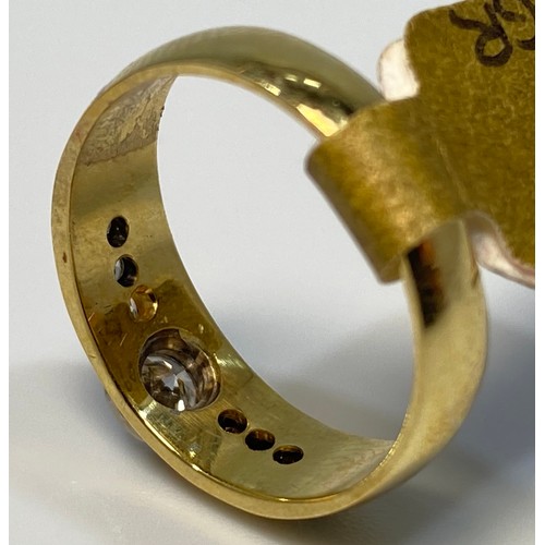 172 - An 18ct yellow gold diamond ring, set with a round brilliant cut diamond to the centre, in a rub-ove... 