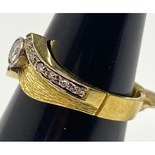 161 - An 18ct gold diamond ring, set with a round brilliant cut diamond to the centre, and six smaller dia... 