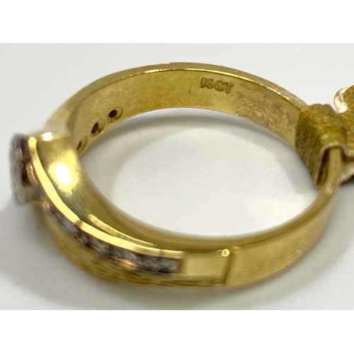 161 - An 18ct gold diamond ring, set with a round brilliant cut diamond to the centre, and six smaller dia... 