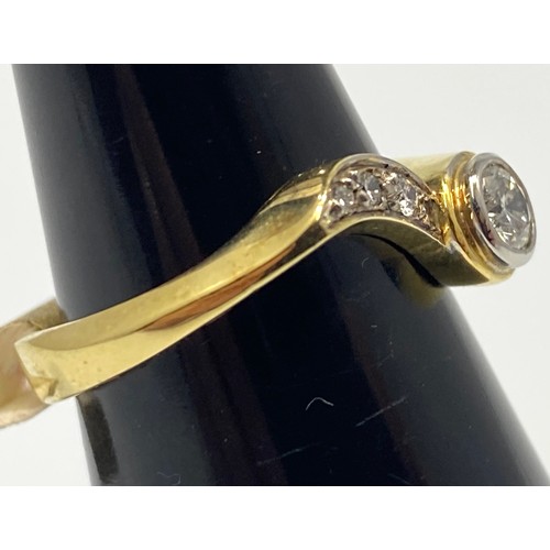 160 - An 18ct yellow gold diamond ring, set with a round brilliant cut diamond in a rub-over setting, with... 