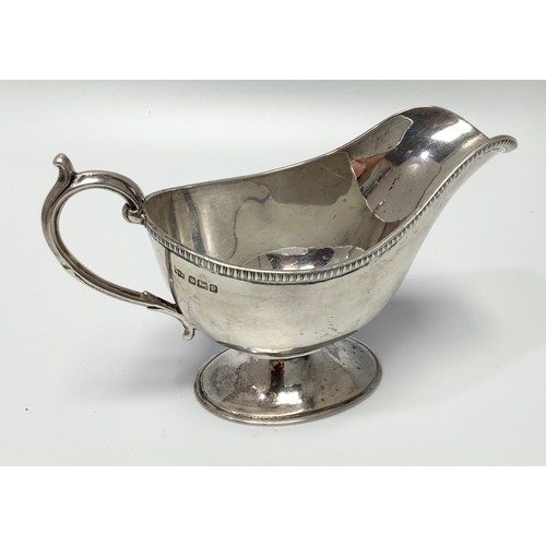 78 - A silver cream jug by Mappin & Webb, of plain design and raised on spreading, oval foot, 13.5cm long... 