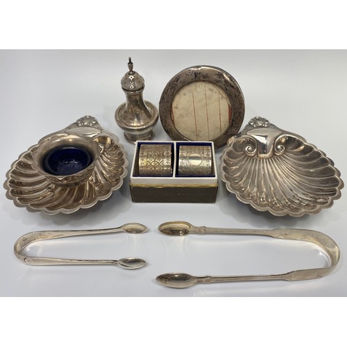 71 - A small collection of assorted silver wares comprising a pair of Georgian sugar tongs, hallmarked Lo... 