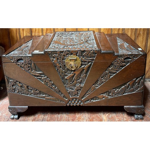 616 - A camphor wood lined Chinese blanket chest, carved with scenes of figures and buildings, raised on b... 