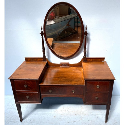 610 - An Edwardian dressing table with central oval mirror, central drawer flanked to two small drawers wi... 