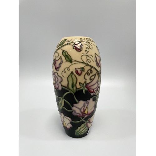 36 - A Moorcroft pottery vase decorated with lavender and yellow flowers to ivory and black  ground, of o... 