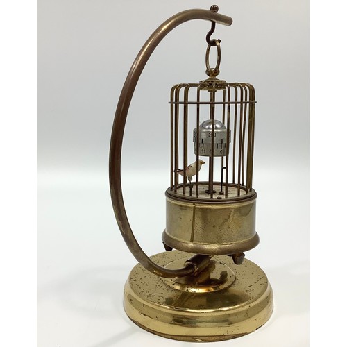 32B - A gilt birdcage automaton clock, probably by Kaiser, with birdcage suspended from a stand with exoti... 