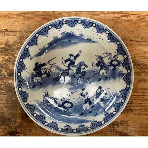 97 - A pair of Chinese porcelain dishes, blue painted underglaze with figural scenes of fighting warriors... 