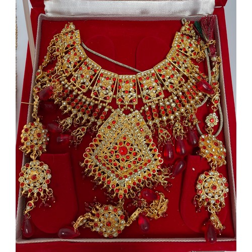 211 - An Indian 22ct gold-plated demi-parure jewellery set, with red and white stones, in retailers box, t... 