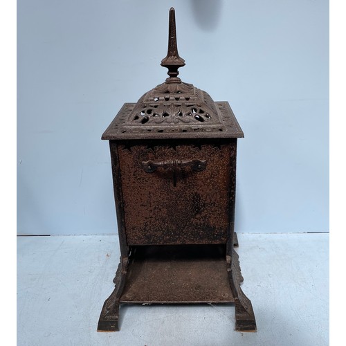 372 - A Rippingilles Patent cast iron stove with red glass panels, twin handles and opposing open sides, 7... 