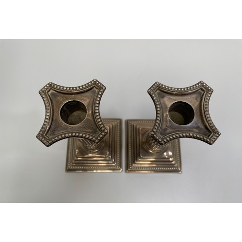 91 - A pair of Victorian silver candlesticks modelled as corinthian columns with detachable beaded sconce... 