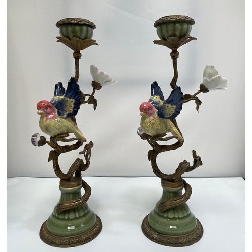 461 - A pair of bronze figural candlesticks by Mark Roberts, with colourful porcelain birds perched on twi... 