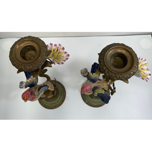 461 - A pair of bronze figural candlesticks by Mark Roberts, with colourful porcelain birds perched on twi... 