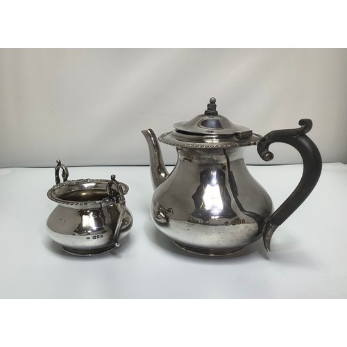 95 - A small silver teapot with beaded foliate rim and ebonised handle, together with a matching twin-han... 