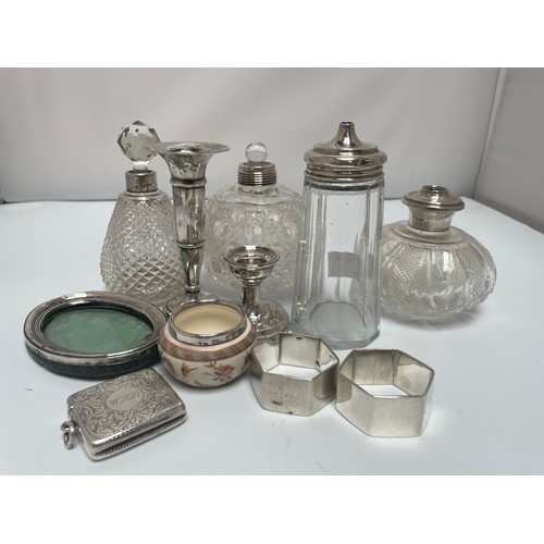 98 - A small collection of assorted silver items including a loaded squat candlestick, a vesta case, hall... 